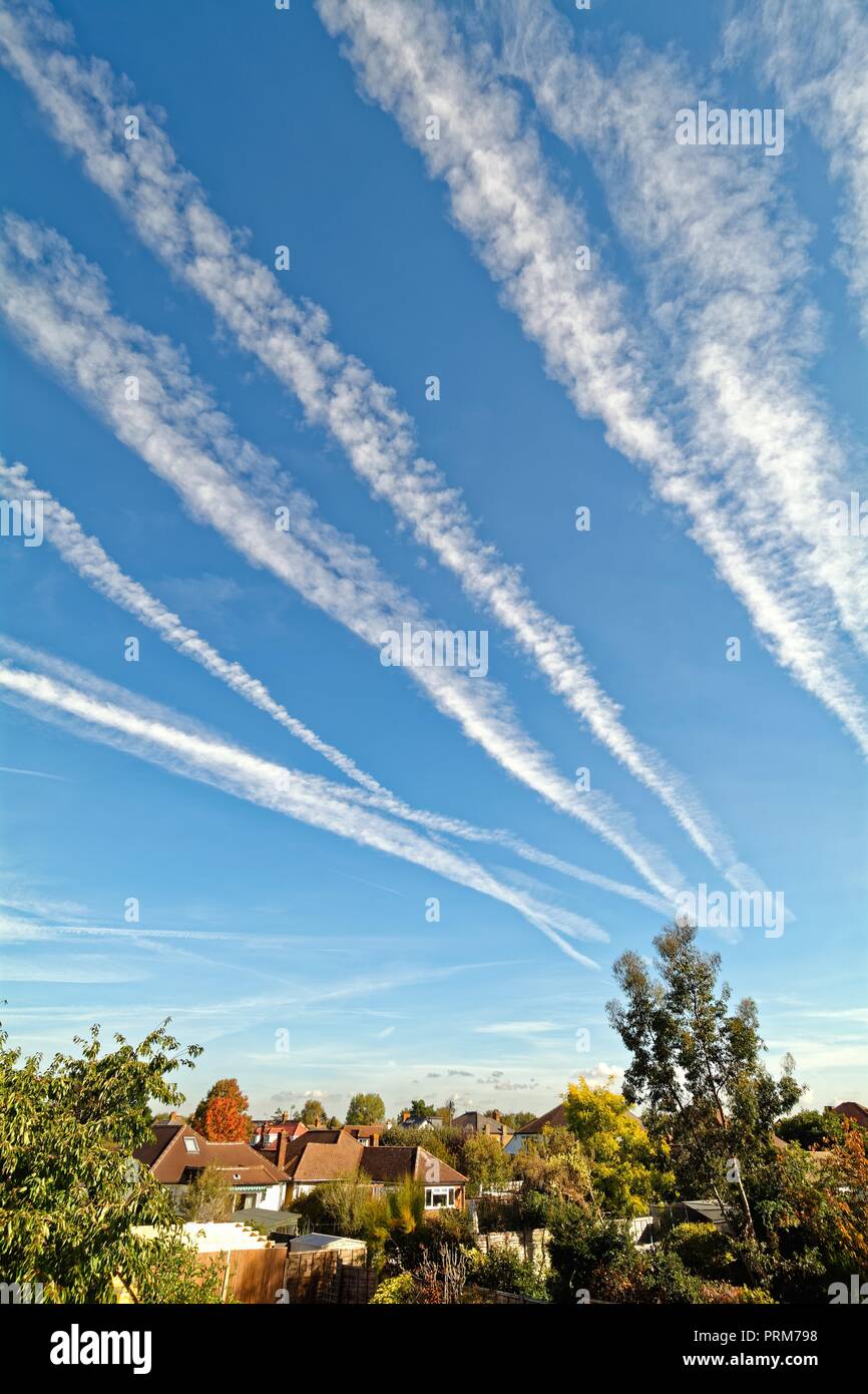 Receding aircraft contrails  against a blue sky Surrey England UK Stock Photo