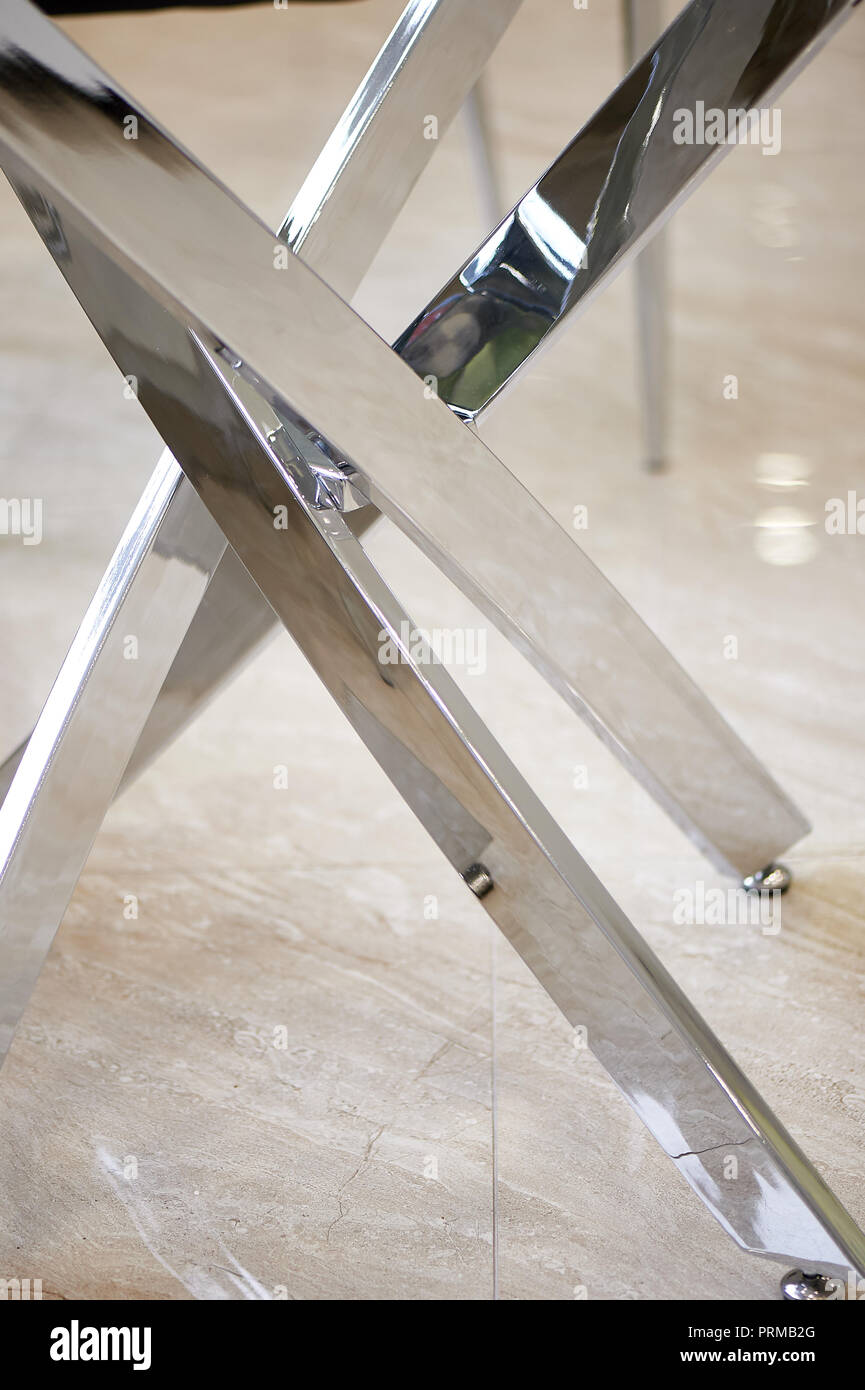 The metal base.Table legs chrome. Modern minimalistic interior Stock Photo