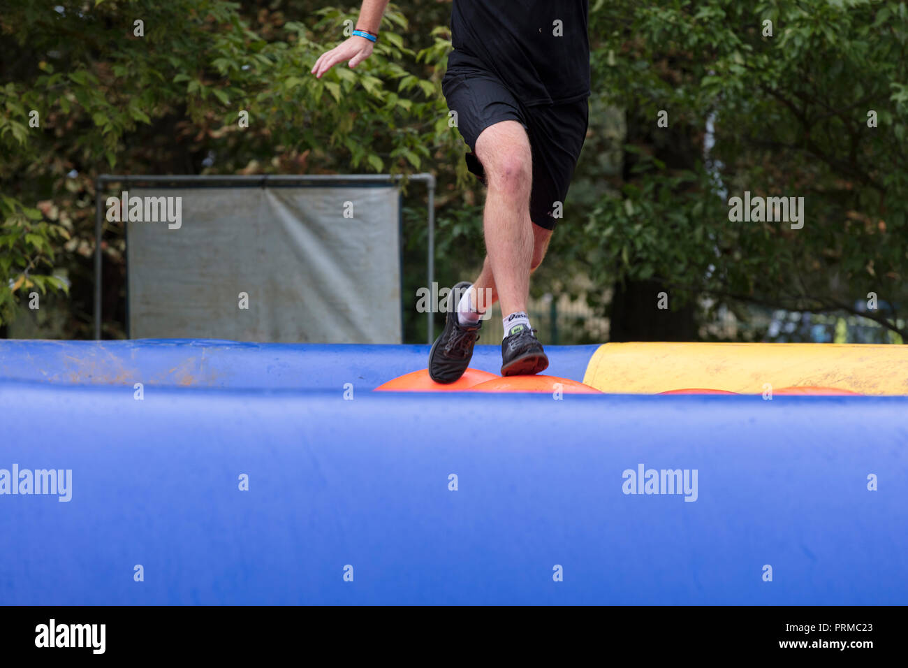 Participant tackles an adventure obstacle course race Stock Photo
