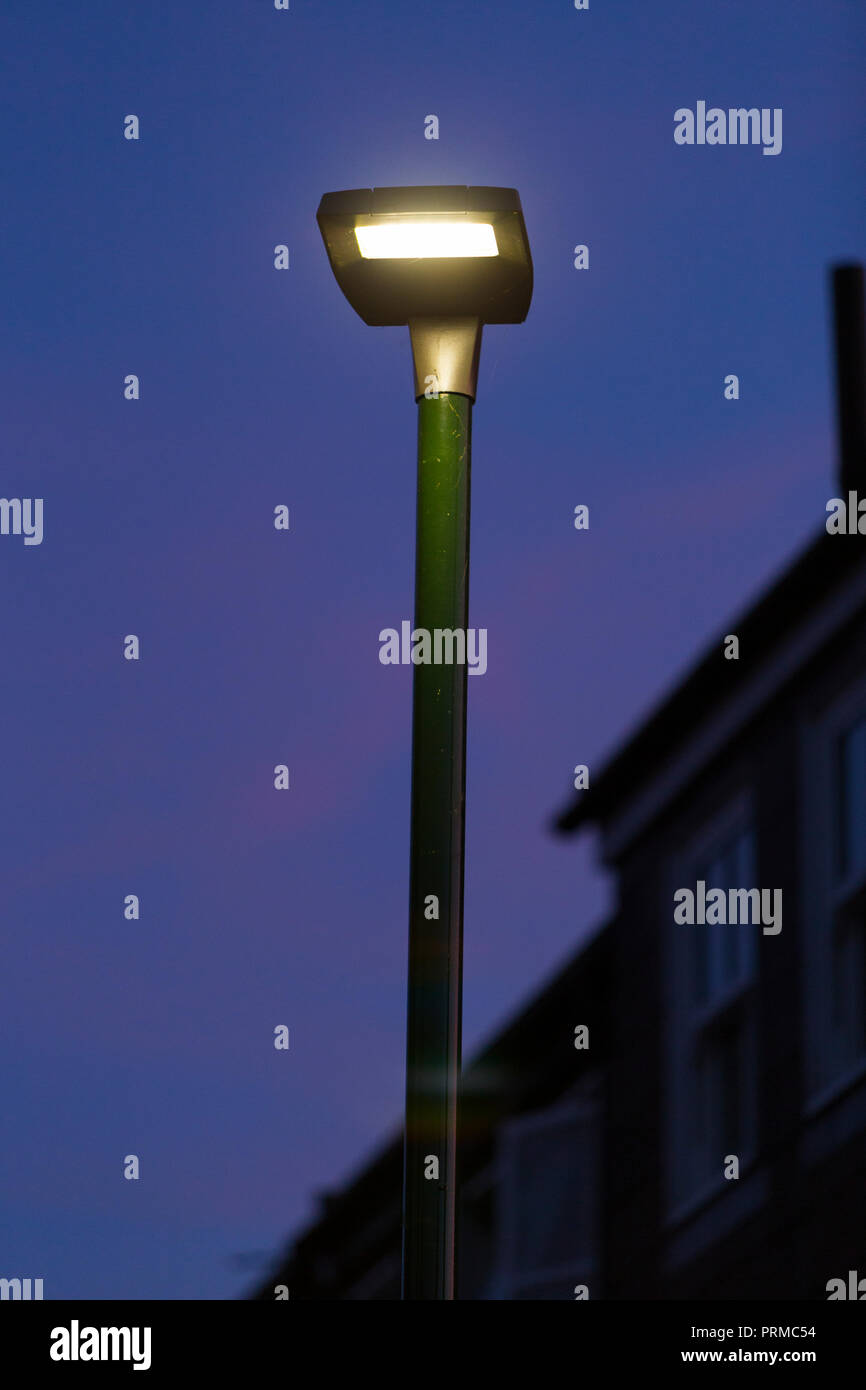 LEDs / LED street lamp head / light / lights up at dusk to illuminate the street. England, UK. (100). Stock Photo