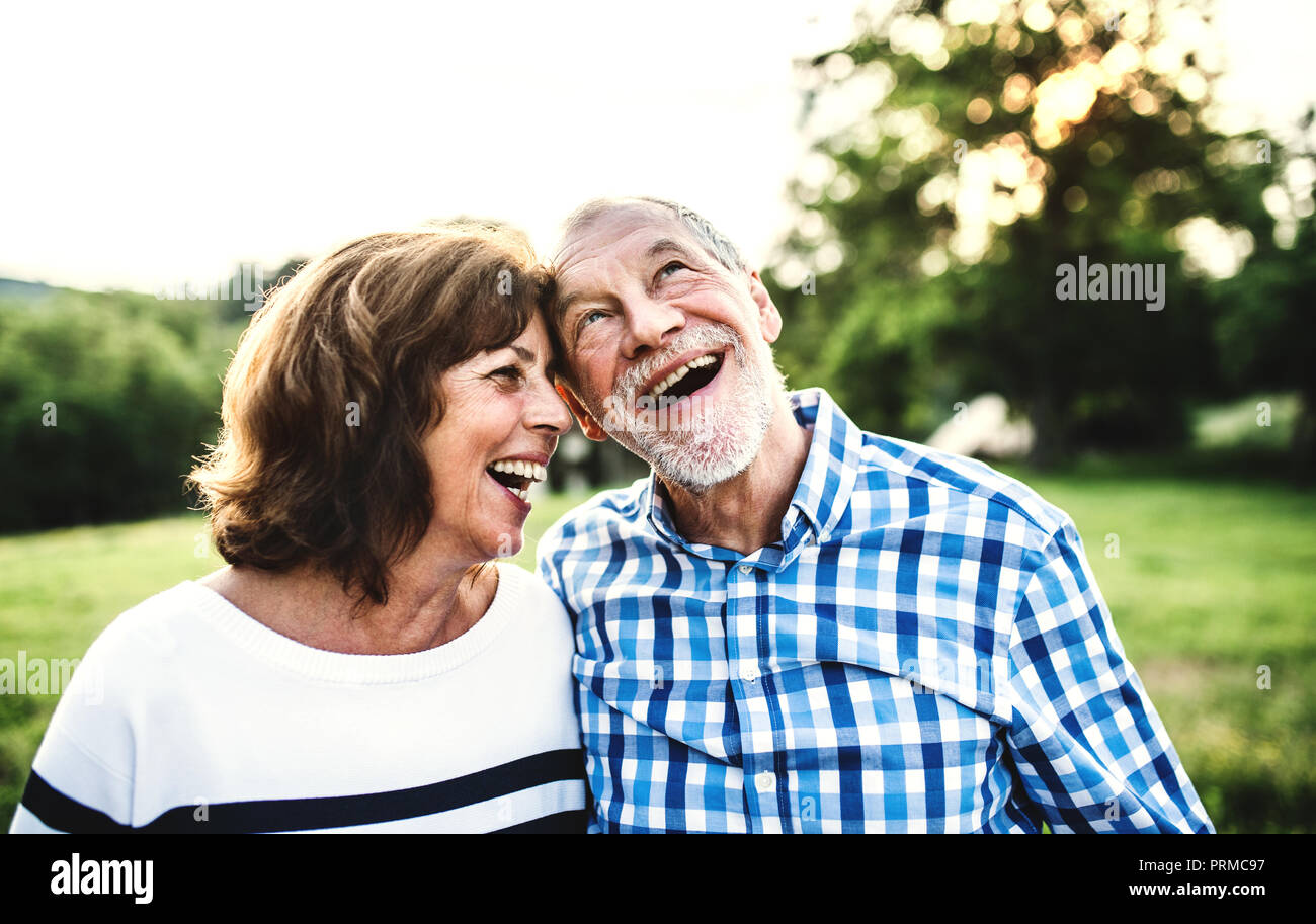 A laughing senior couple in love outdoors in nature. Stock Photo