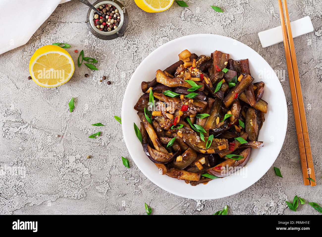 Hot spicy stew eggplant in Korean style with green onion. Aubergine saute. Vegan food. Flat lay