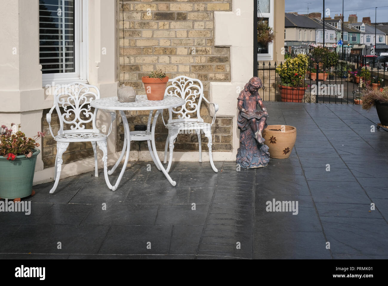 Table and chairs on patio Stock Photo