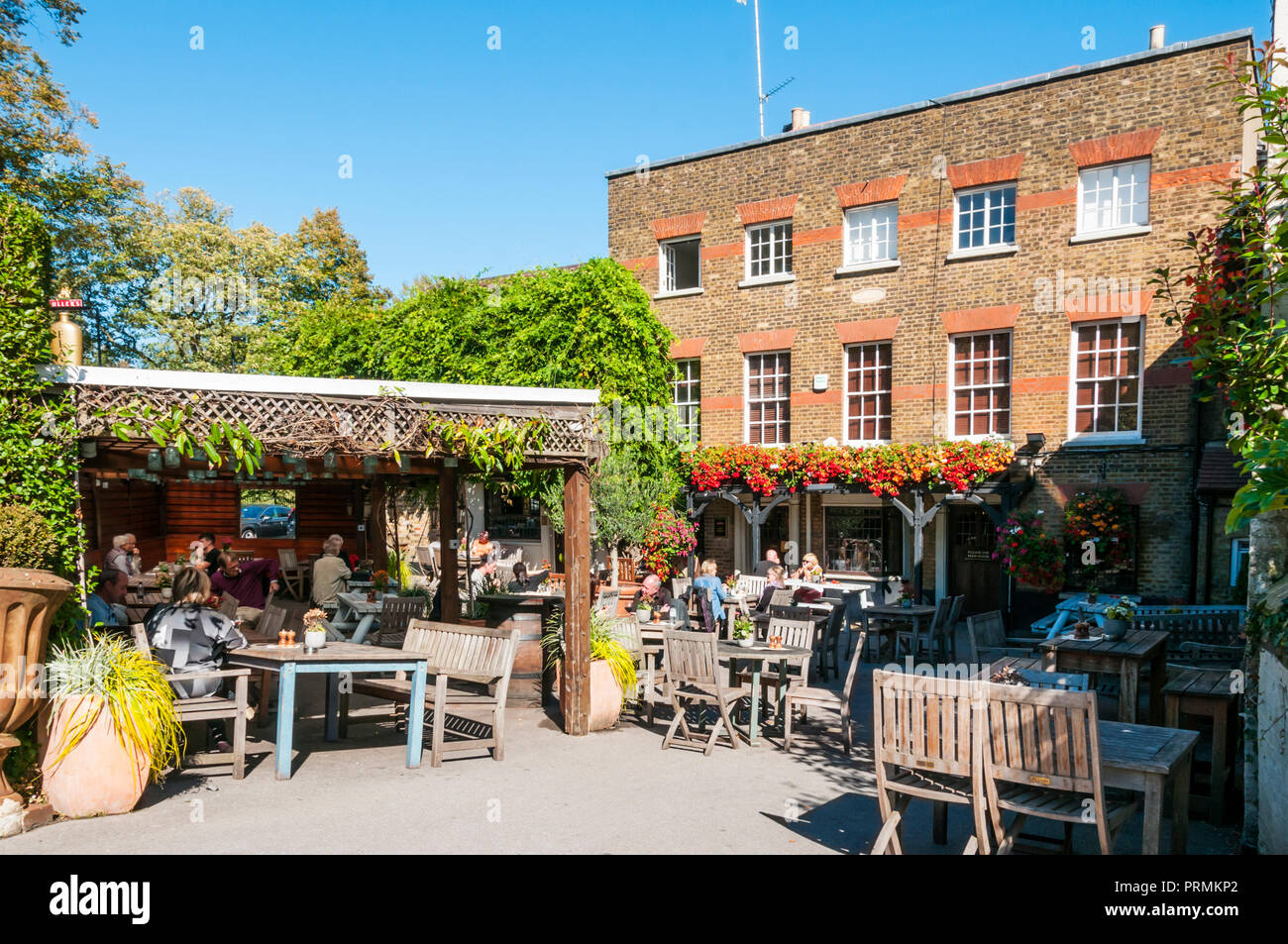 People drinking outside the Flask public house on a sunny day in Highgate, North London. Stock Photo