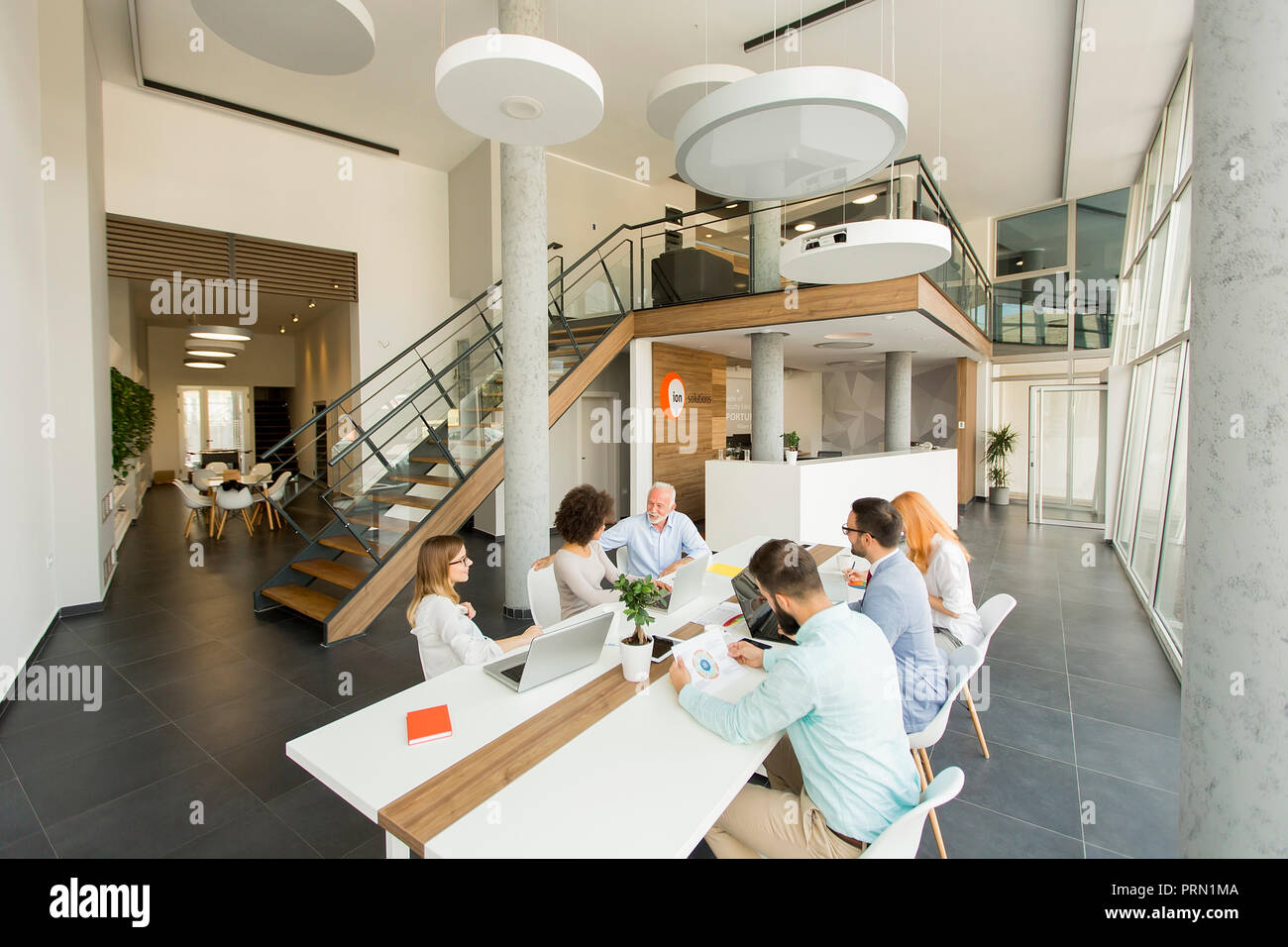 View at group of business people working in the office Stock Photo - Alamy