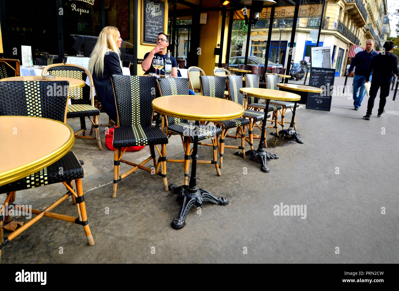 People drinking and smoking outside a cafe, Paris, France. Stock Photo