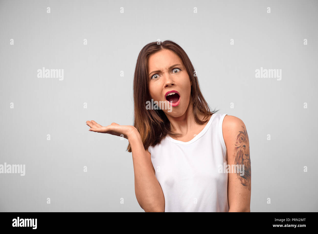 Are you kidding me? Studio portrait of attractive young brunette woman being shocked to receive astonishing news that she finally got promotion at wor Stock Photo