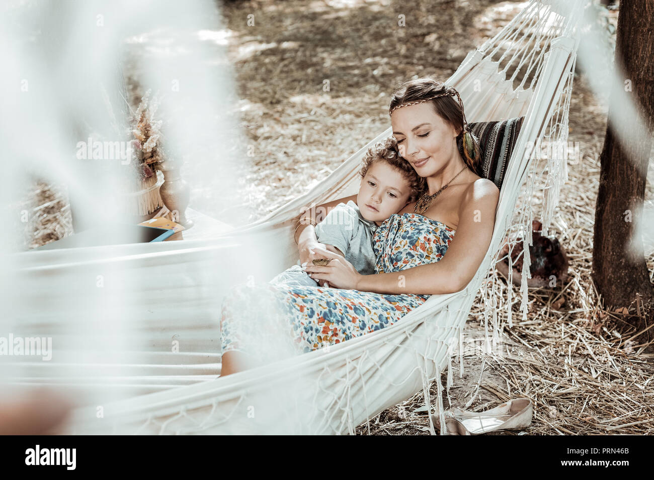 Happy mother and son lying in a hammock Stock Photo