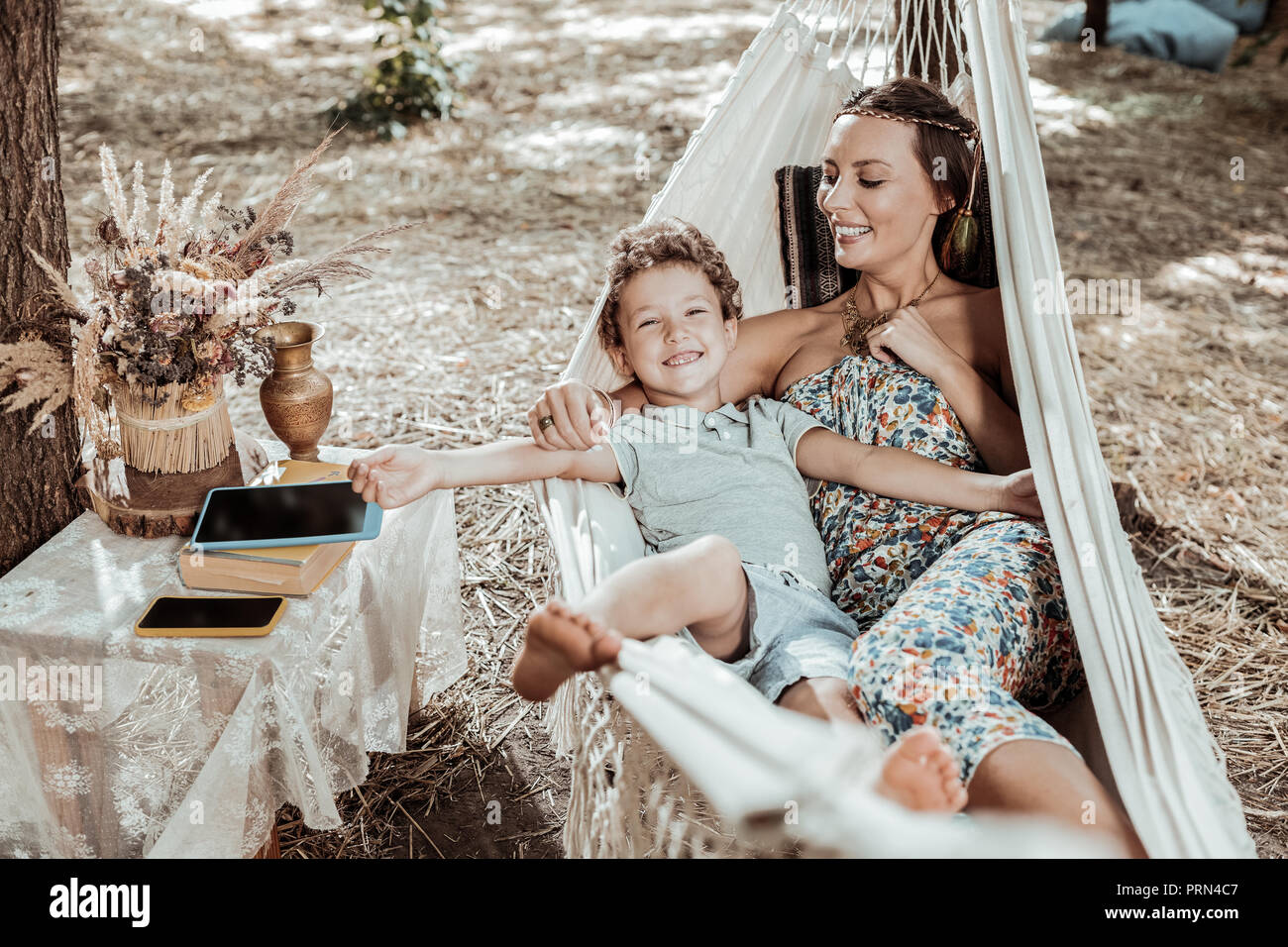 Sweet nice child resting with his mom Stock Photo - Alamy