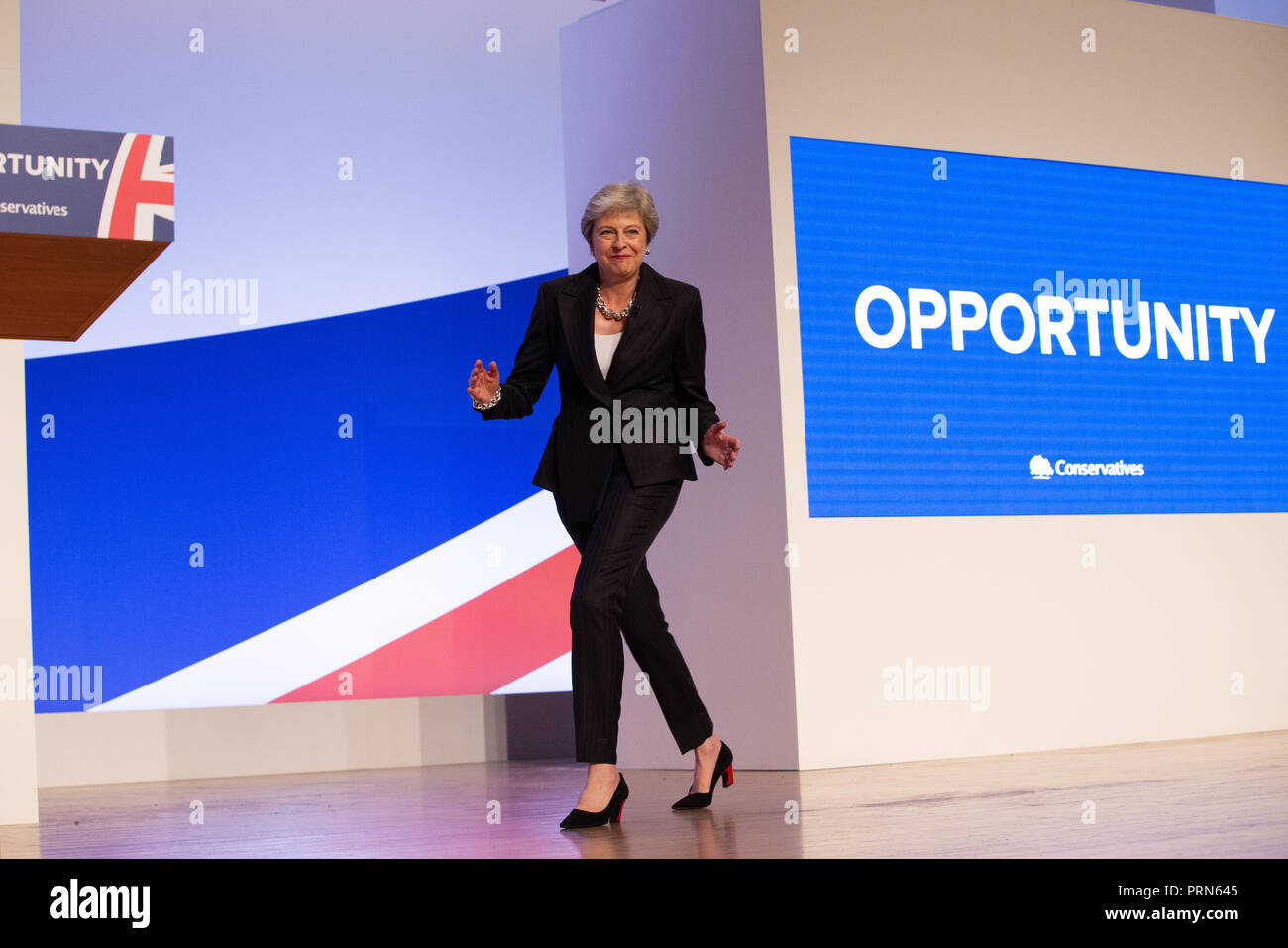 Birmingham, UK. 3rd Oct 2018. Theresa May walks on stage to the tune of 'Dancing Queen' by Abba and starts dancing before she delivers her Leaders' speech to the Conservative Party Conference in Birmingham. Credit: Mark Thomas/Alamy Live News Stock Photo