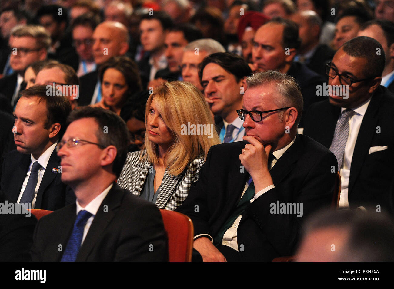 Birmingham, England. 3rd October, 2018.  L-R Esther McVey, Secretary of State for Work and Pensions and Michael Gove MP, Secretary of State for Environment, Food and Rural Affairs, listening to the keynote speech of Theresa May MP, Prime Minister and Leader of the Conservative Party, on the closing session of the fourth day of the Conservative Party annual conference at the ICC.  Kevin Hayes/Alamy Live News Stock Photo