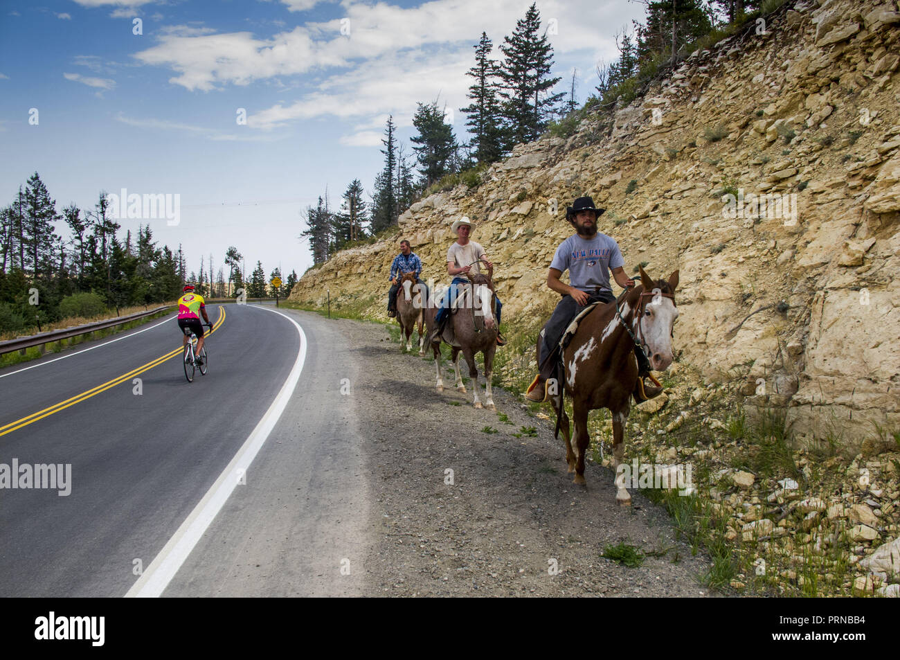 Portland, Oregon, USA. 17th Sep, 2013. A bicyclist pedals past men on horseback as they make their way along Dead Indian Pass on the Chief Joseph Scenic Byway in Wyoming. Credit: L.E. Baskow/ZUMA Wire/Alamy Live News Stock Photo