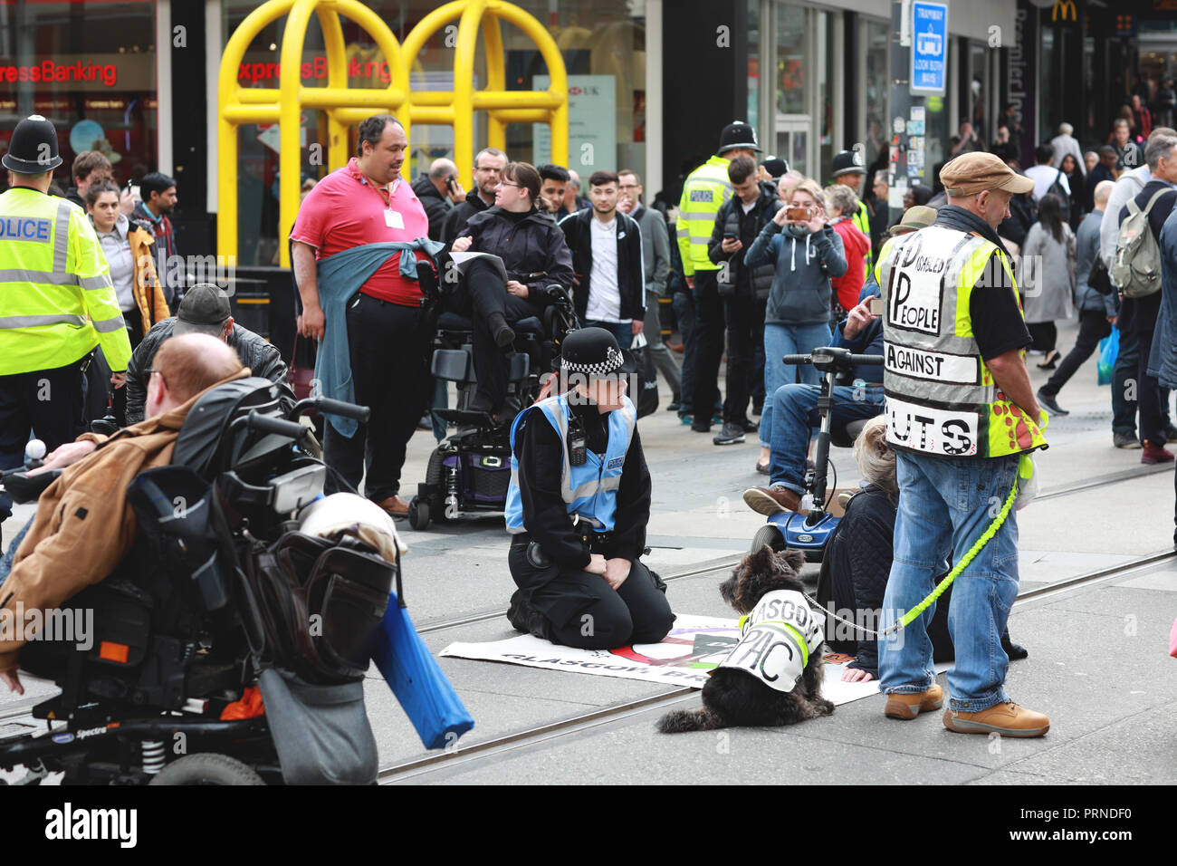 Birmingham, UK. 3rd October, 2018. Police try to negotiate with disabled rights protestors who blocked the main tramline out of Birmingham New Street station for about an hour yesterday afternoon  .They were demonstrating against the Conservative Government implimentation of austerity cuts . Research by the Joseph Rowntree Foundation found around 650,000 people with mental and physical health problems were officially destitute in the UK last year. Credit: Paul Pickard/Alamy Live News Stock Photo