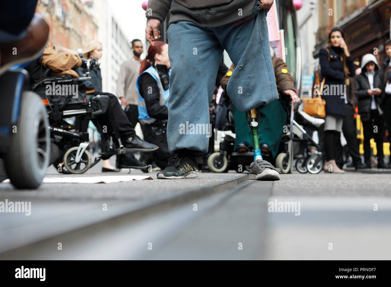 Birmingham, UK. 3rd October, 2018. Police try to negotiate with disabled rights protestors who blocked the main tramline out of Birmingham New Street station for about an hour yesterday afternoon  .They were demonstrating against the Conservative Government implimentation of austerity cuts . Research by the Joseph Rowntree Foundation found around 650,000 people with mental and physical health problems were officially destitute in the UK last year. Credit: Paul Pickard/Alamy Live News Stock Photo