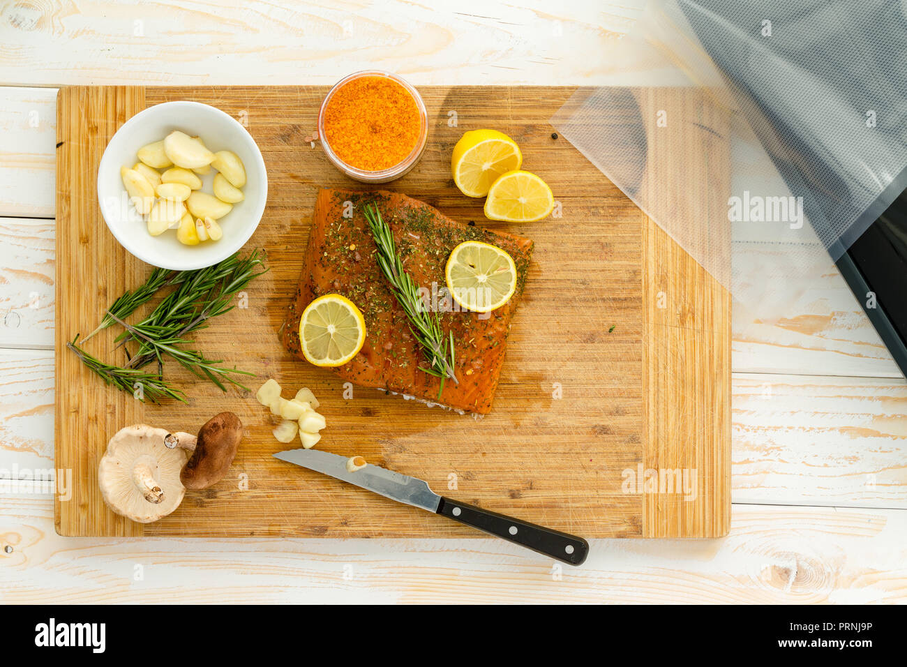 Preparing salmon for sous vide dinner with rosemary garlic, lemon and gochujang infused seasalt Stock Photo