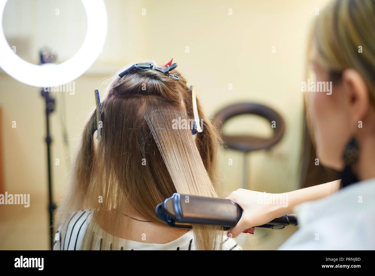 Hairdressing services. Hair styling process in a beauty salon. Stock Photo