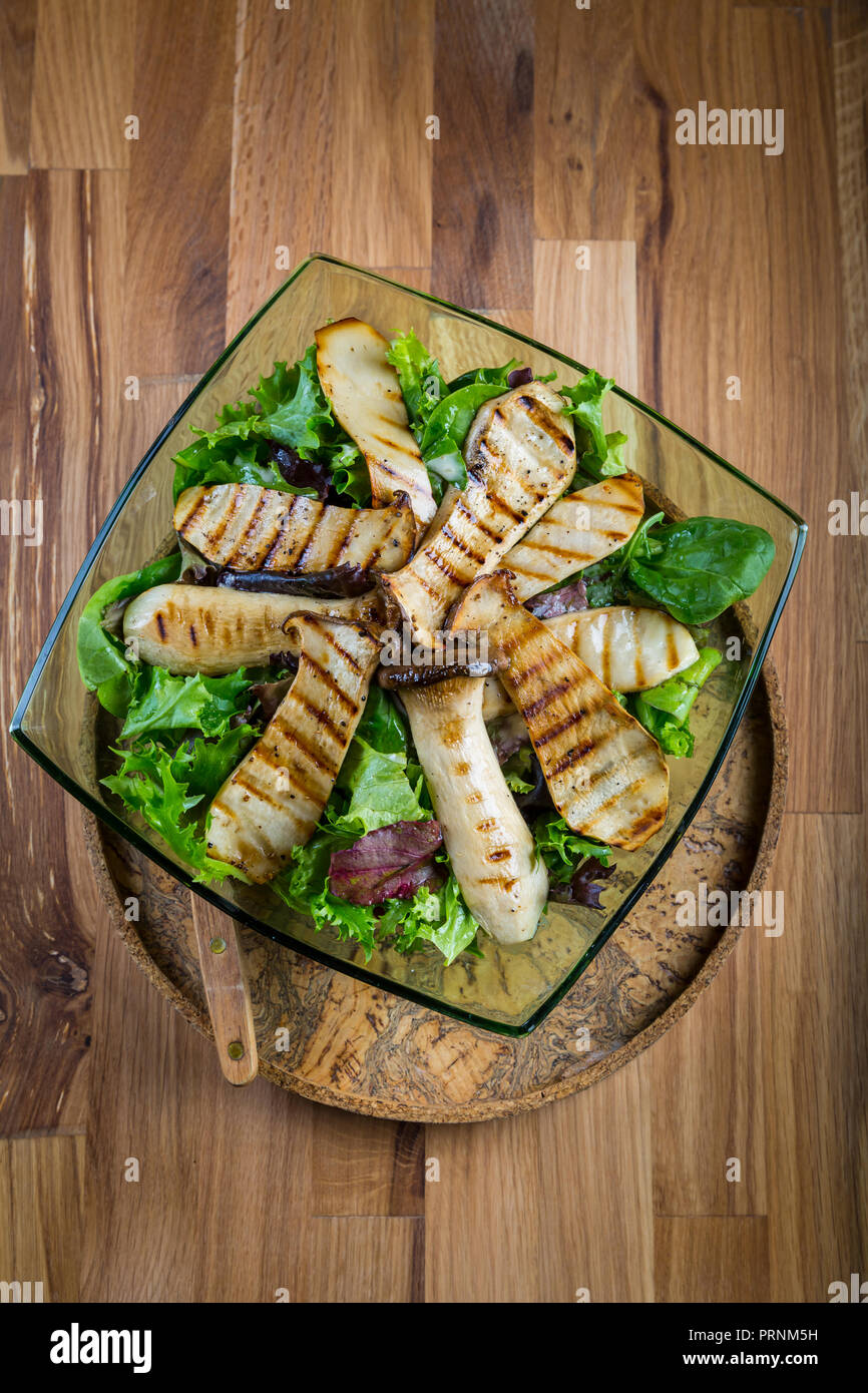 Green vegetable salad with grilled king oyster mushrooms Stock Photo