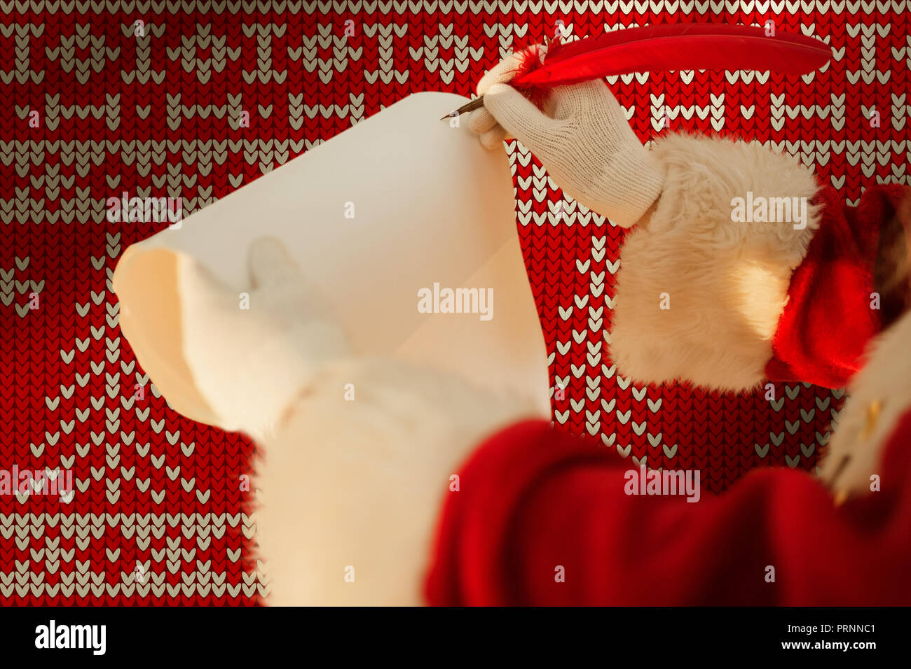 Composite image of santas hand writing list with a quill Stock Photo