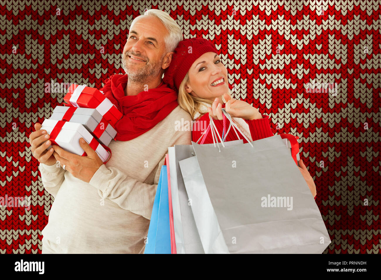 Composite image of happy festive couple with gifts and bags Stock Photo