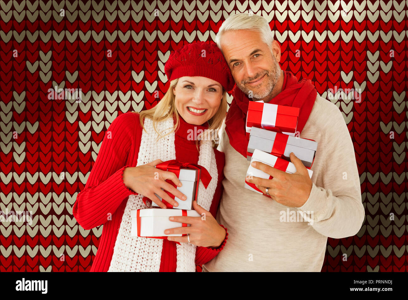 Composite image of happy festive couple with gifts Stock Photo