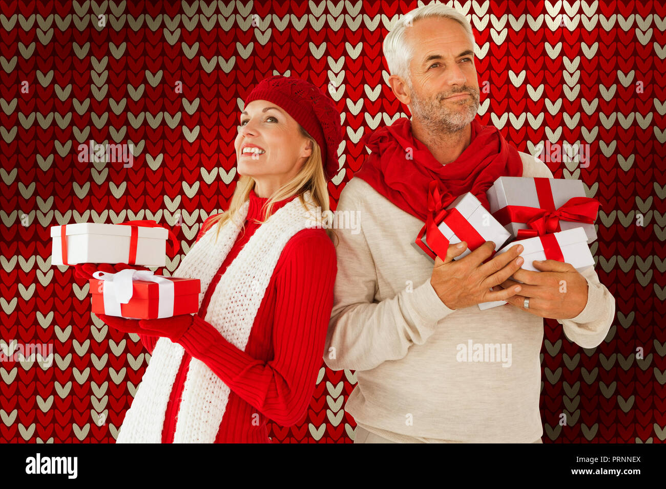 Composite image of happy festive couple with gifts Stock Photo
