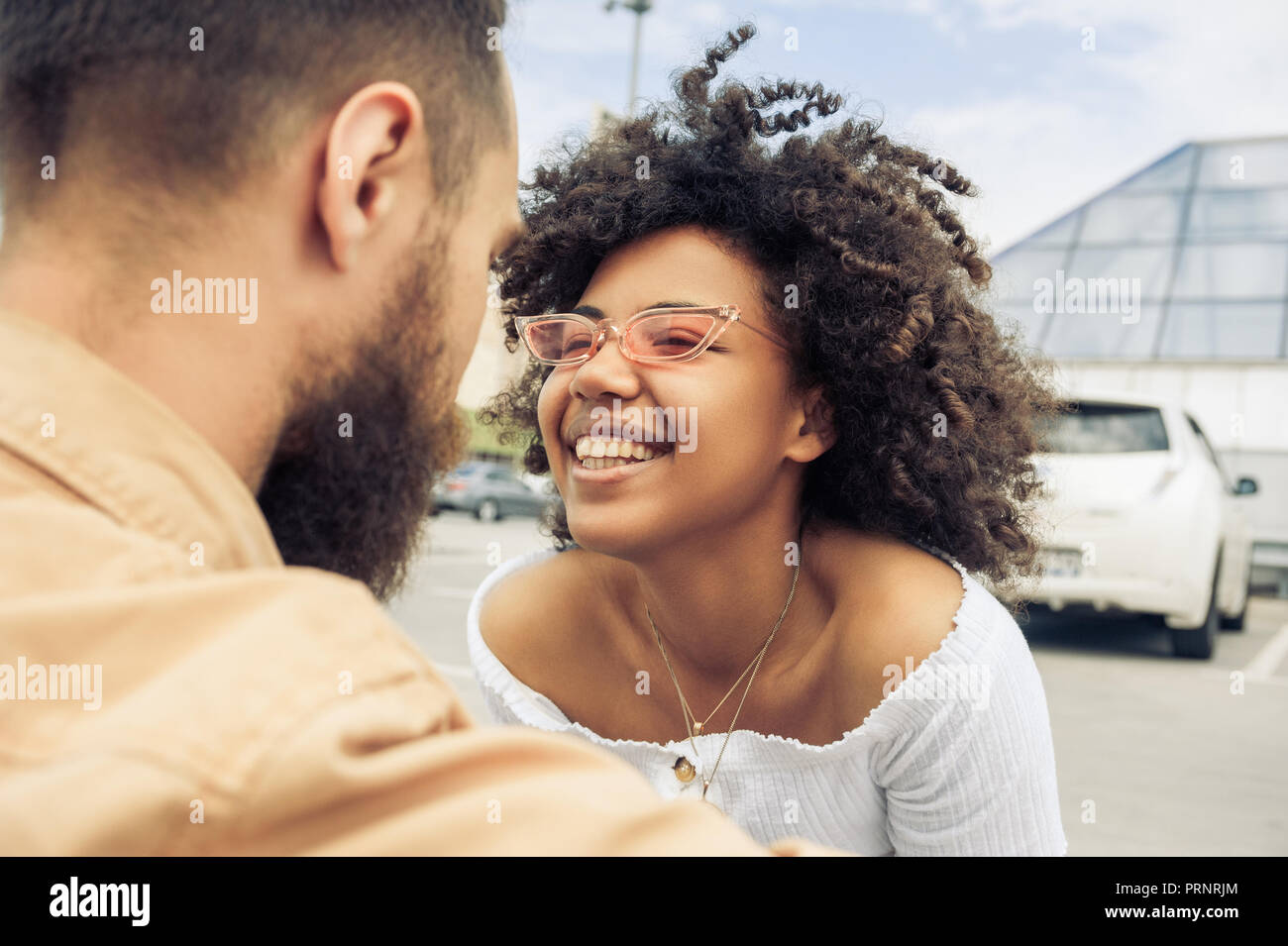 beautiful happy young multiracial couple laughing together on street Stock Photo