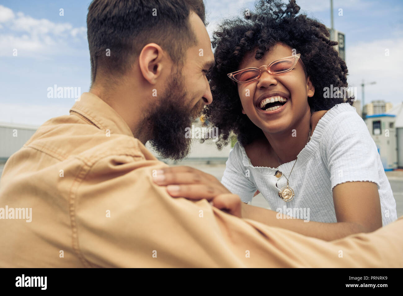 happy young multiethnic couple having fun and laughing on street Stock Photo