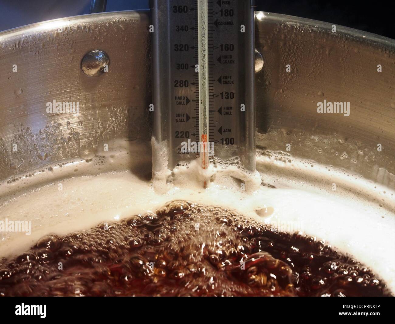 Homemade Apple Jelly (Jam) reaching setting point in a Maslin Pan Stock