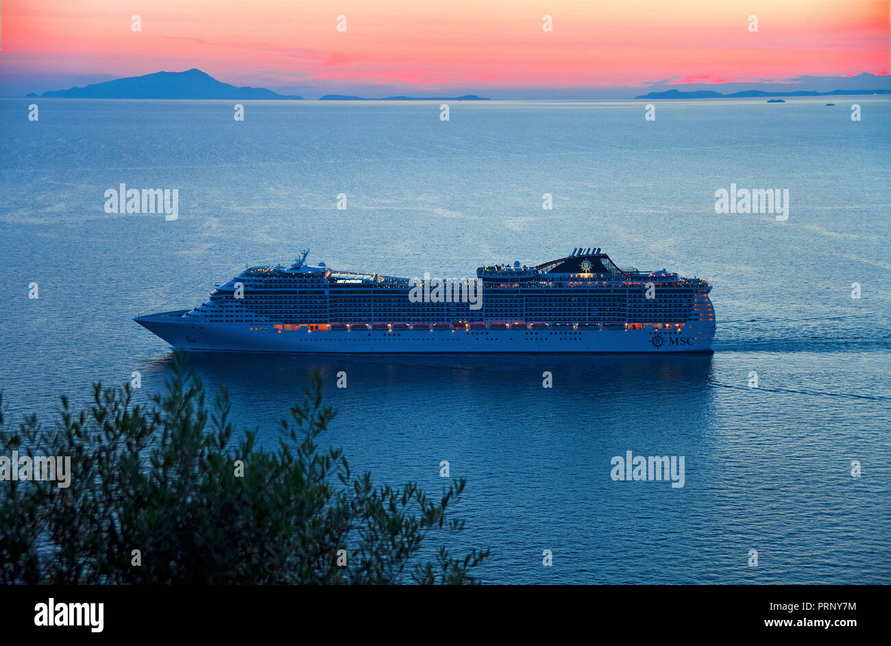 Cruise ship at sunset, view from Sorrento peninsula, left side behind Capri island, Gulf of Naples, Campania, Italy Stock Photo