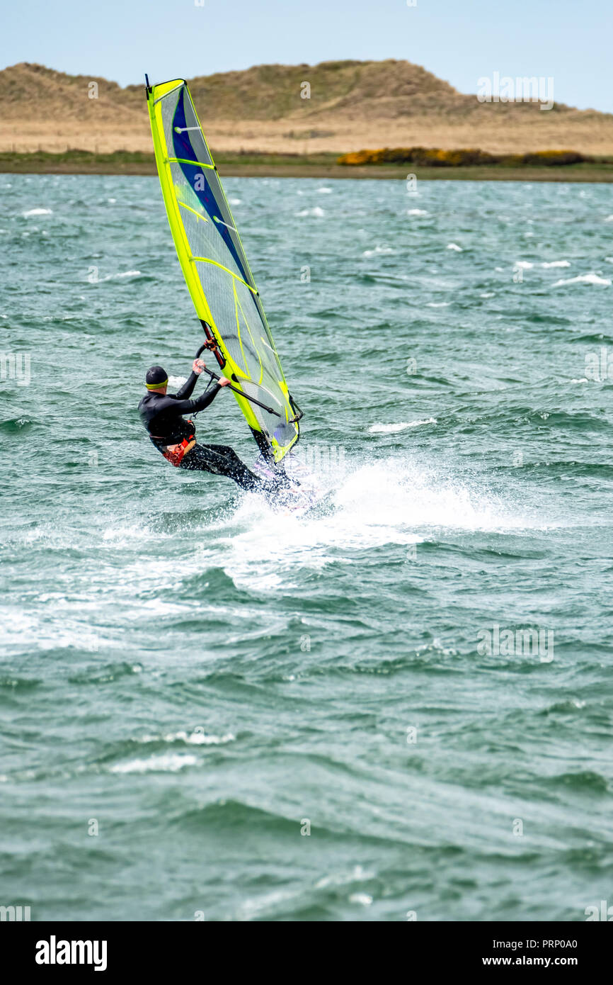 Man windsurfing close to the town of Caernarfon in Wales United