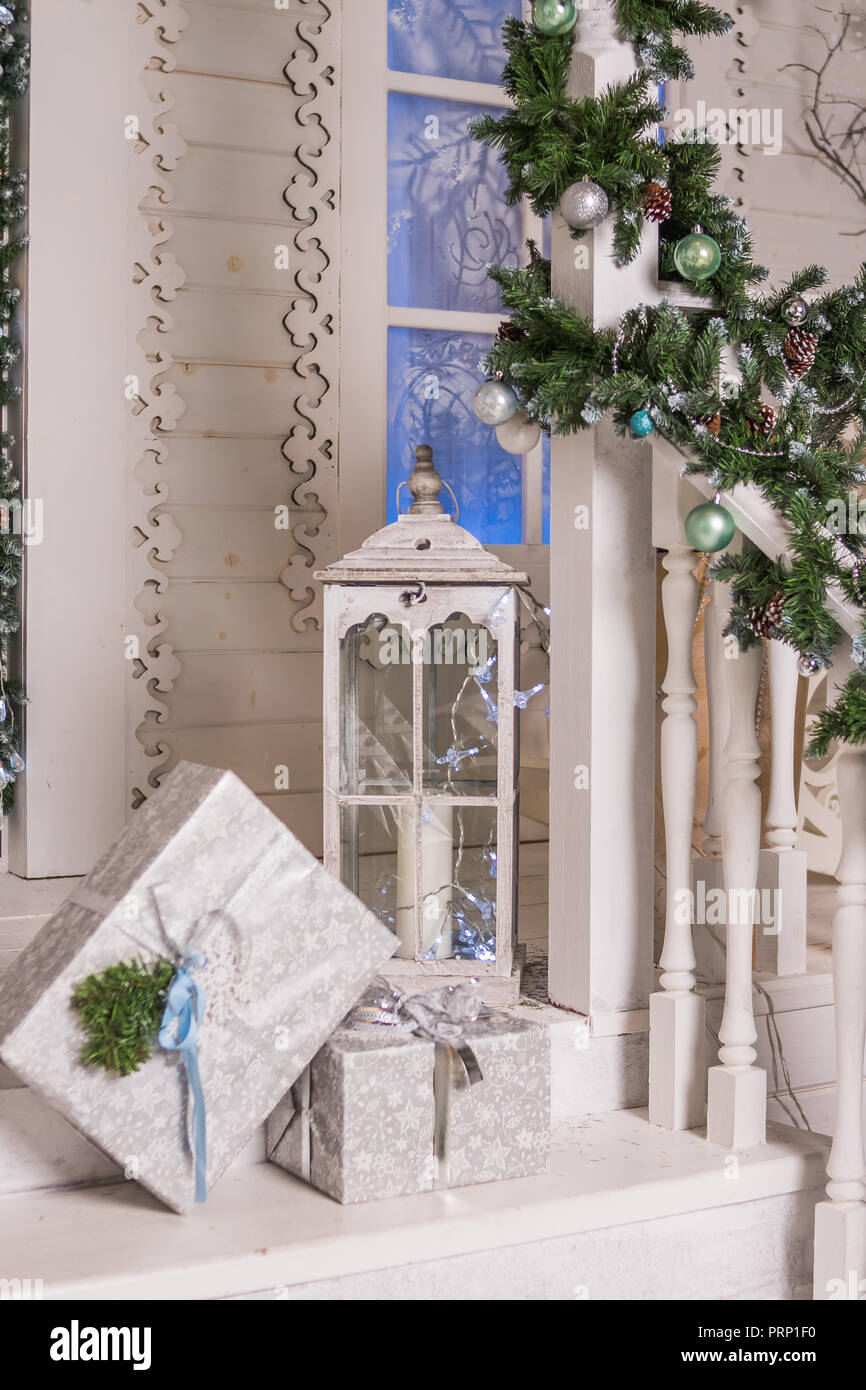 Winter Exterior Of A Country House With Christmas Decorations Wooden Vintage Porch House Decorated And Lighted For Christmas And For New Year Eve Big White Lantern Gift Boxes And Balls Stock Photo