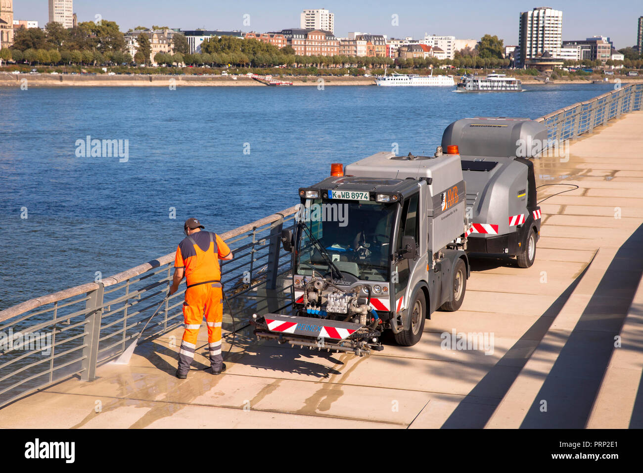 cleaning the boardwalk of the Rhine boulevard in Deutz, Cologne, Germany.  Reinigung des Rheinboulevards in Deutz, Koeln, Deutschland. Stock Photo