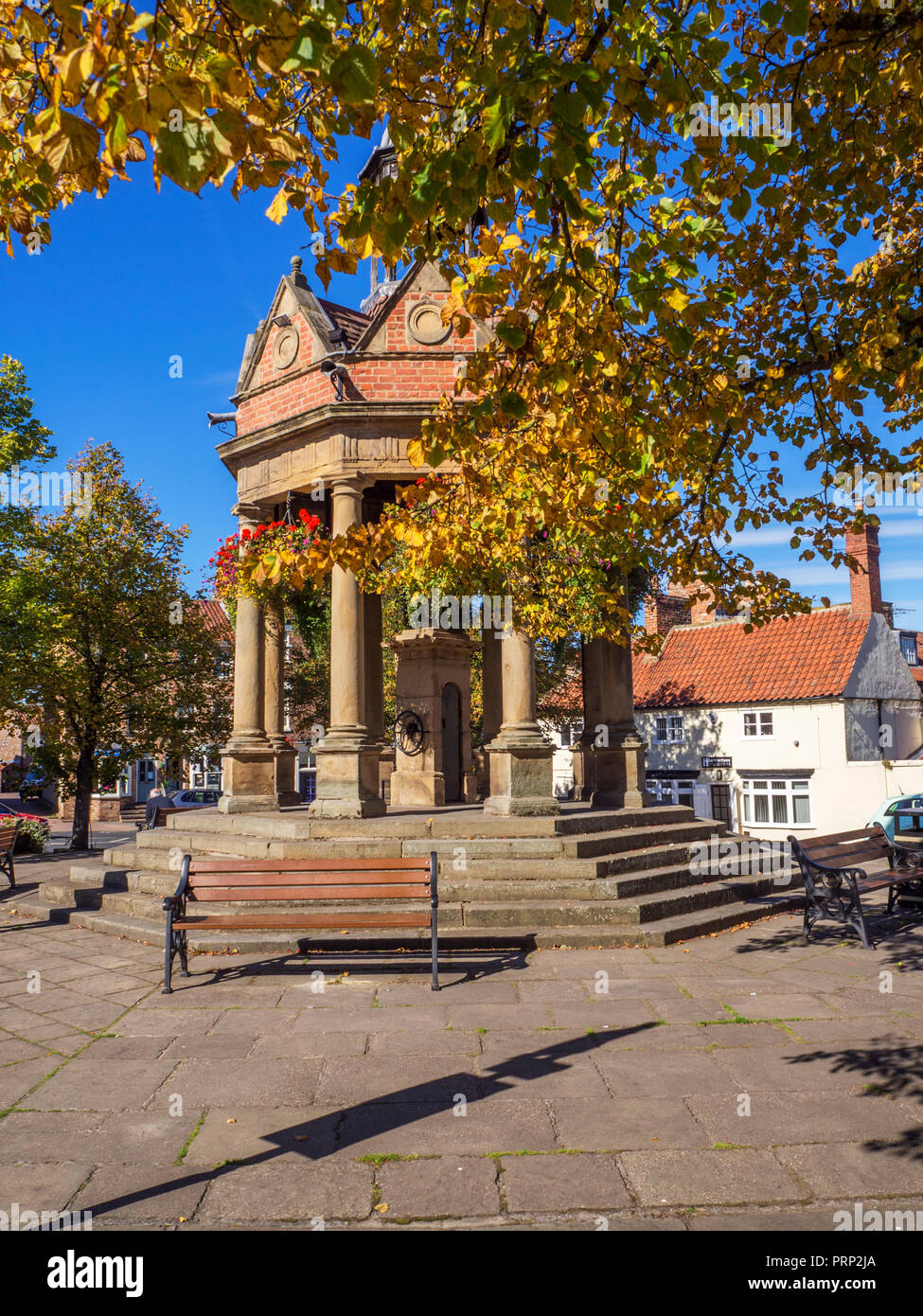 The Fountain former water pump in St James Square in early autumn at Boroughbridge North Yorkshire England Stock Photo