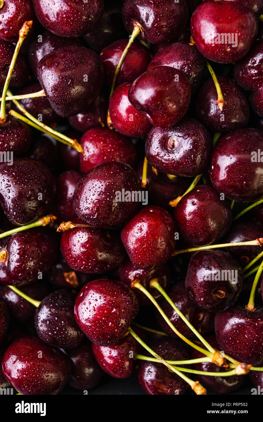 Ripe cherries with waterdrops background. Closeup view. Stock Photo