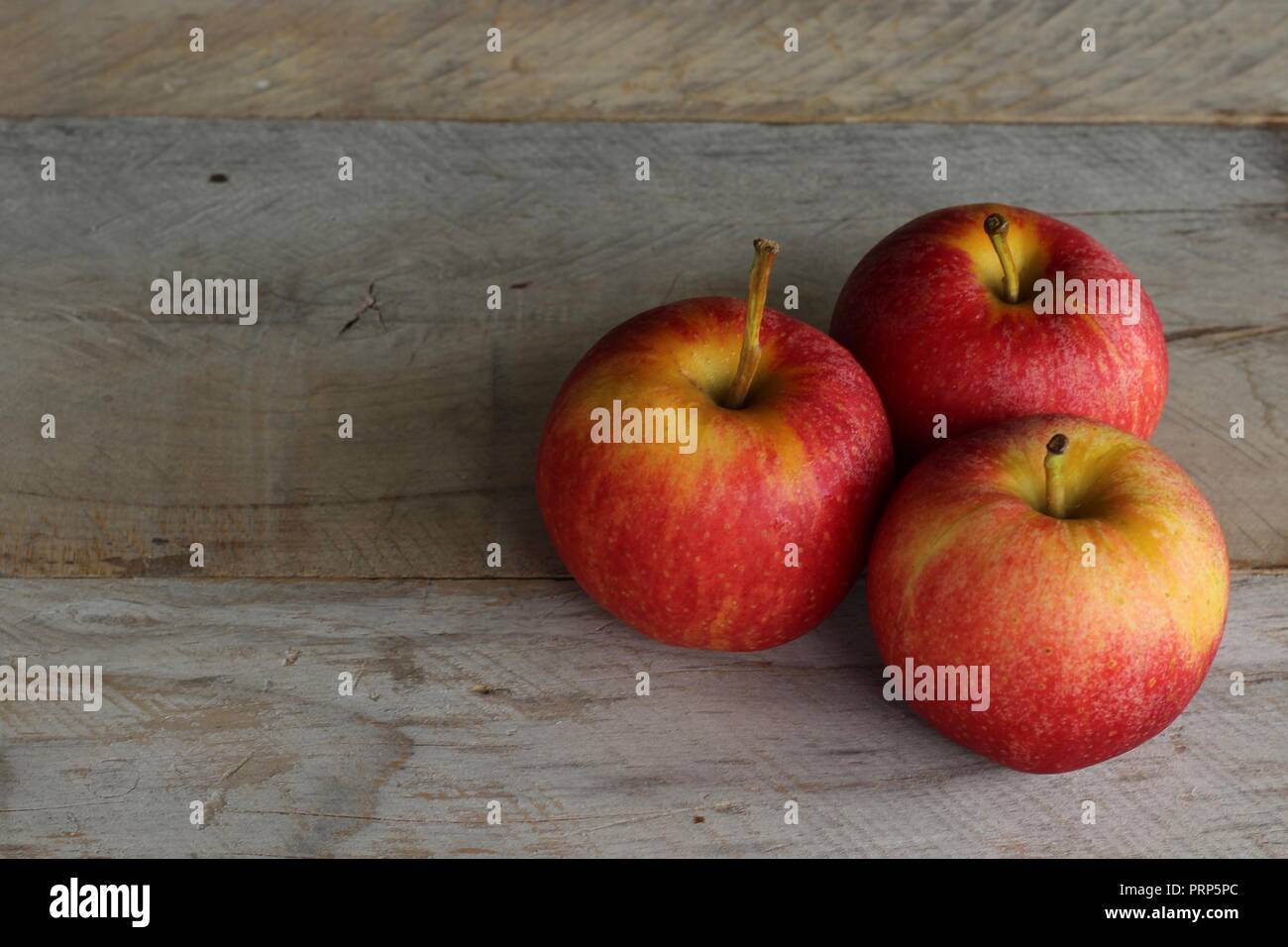 three apples on wood table Stock Photo