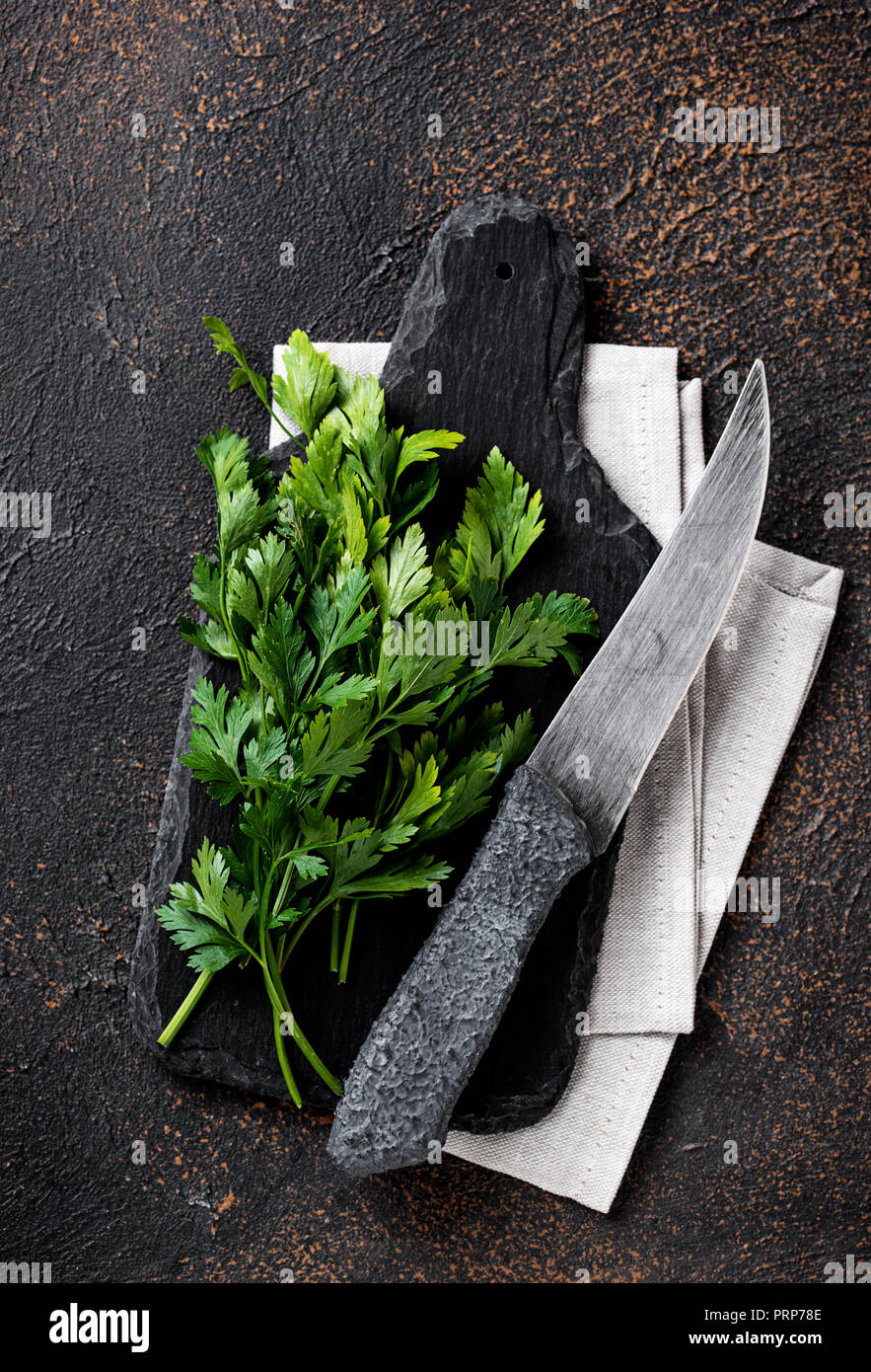Parsley and knife on cutting board Stock Photo
