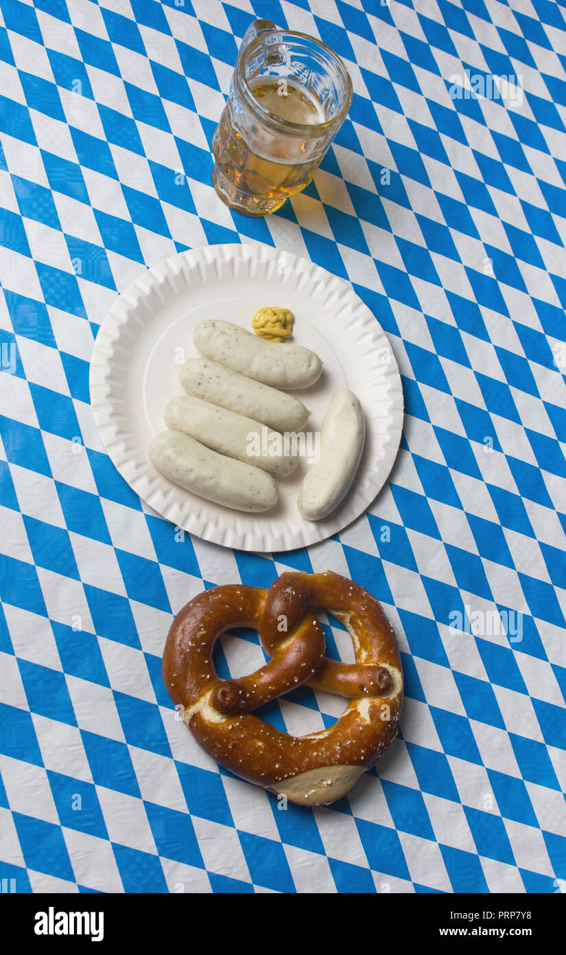 top view of Sailed pretzel, white sausages and beer on table to celebrate the bavarian Oktoberfest Stock Photo
