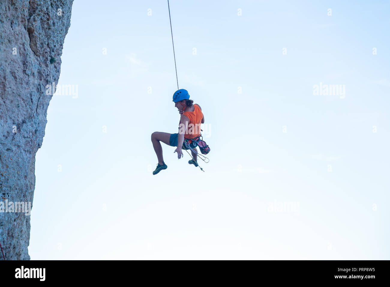 Man hanging on cliff hi-res stock photography and images - Alamy