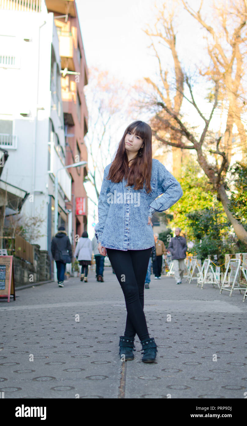 Japanese Girl poses on the street in Kichijoji, Japan. Kichijoji is a ...