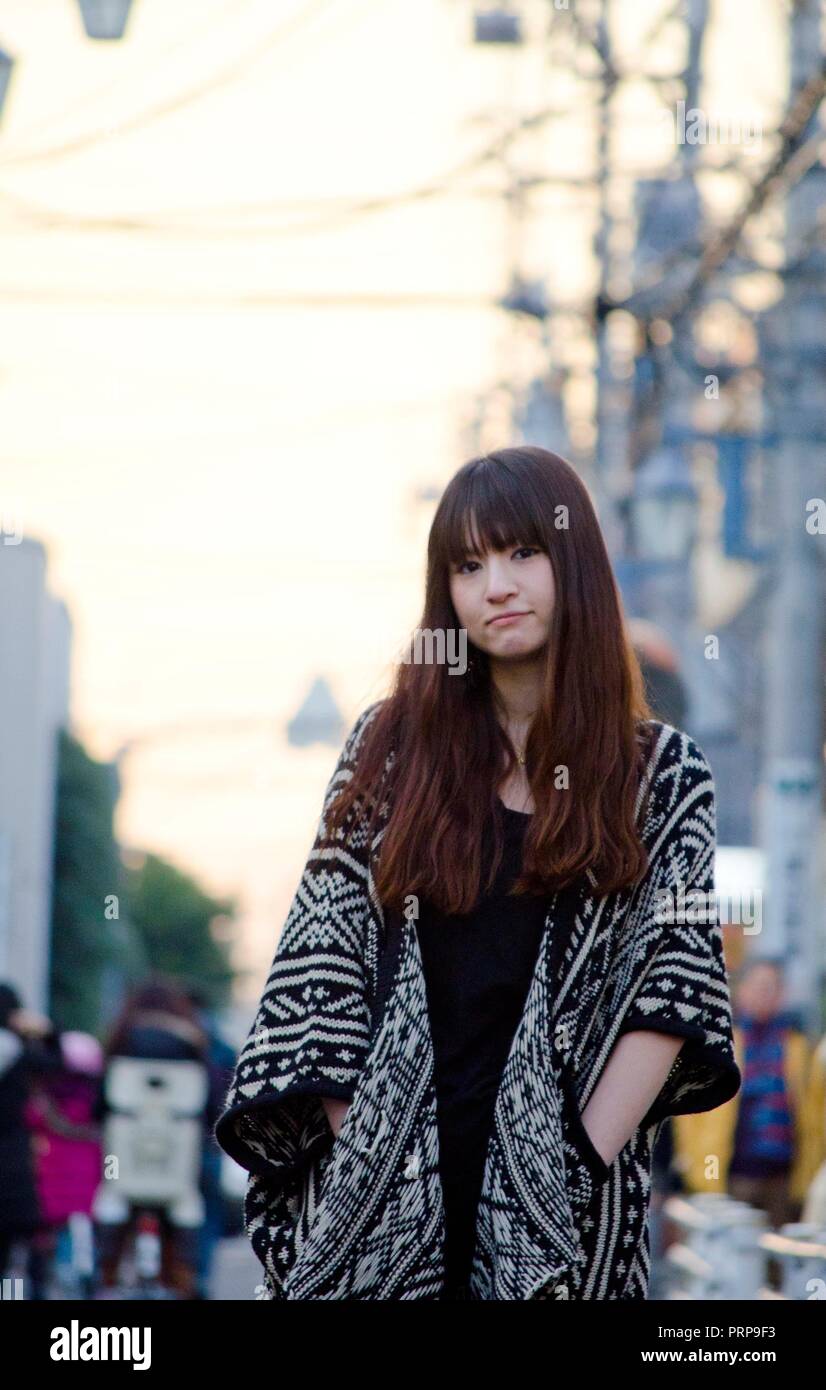 Japanese Girl poses on the street in Kichijoji, Japan. Kichijoji is a ...