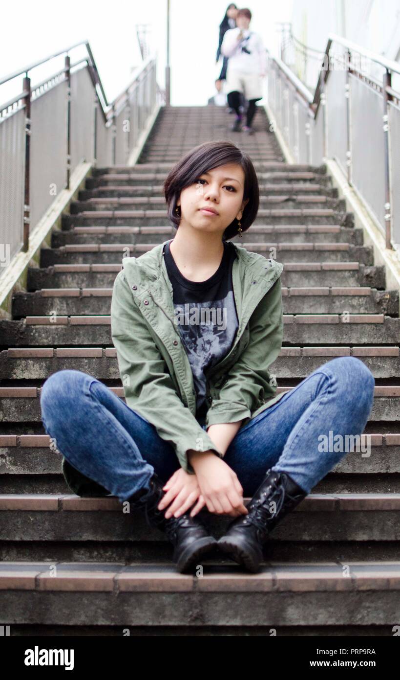 Japanese Girl poses on the street in Machida, Japan. Machida is an