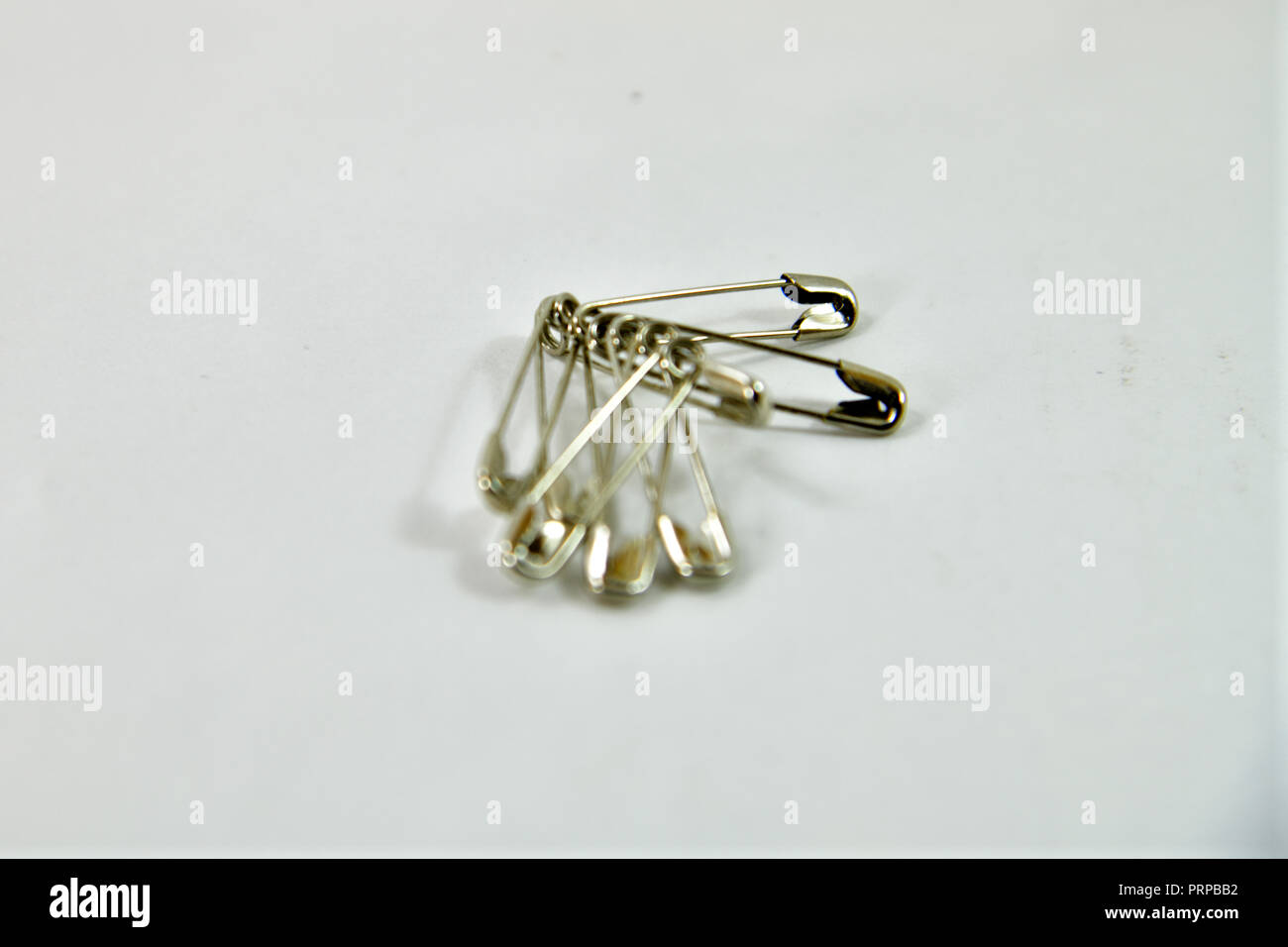 Safety pin isolated on white background Stock Photo - Alamy