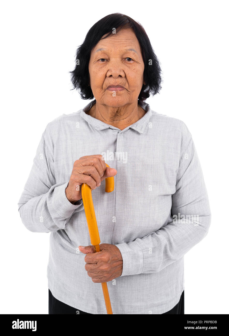 senior woman with a walking cane isolated on a white background Stock Photo