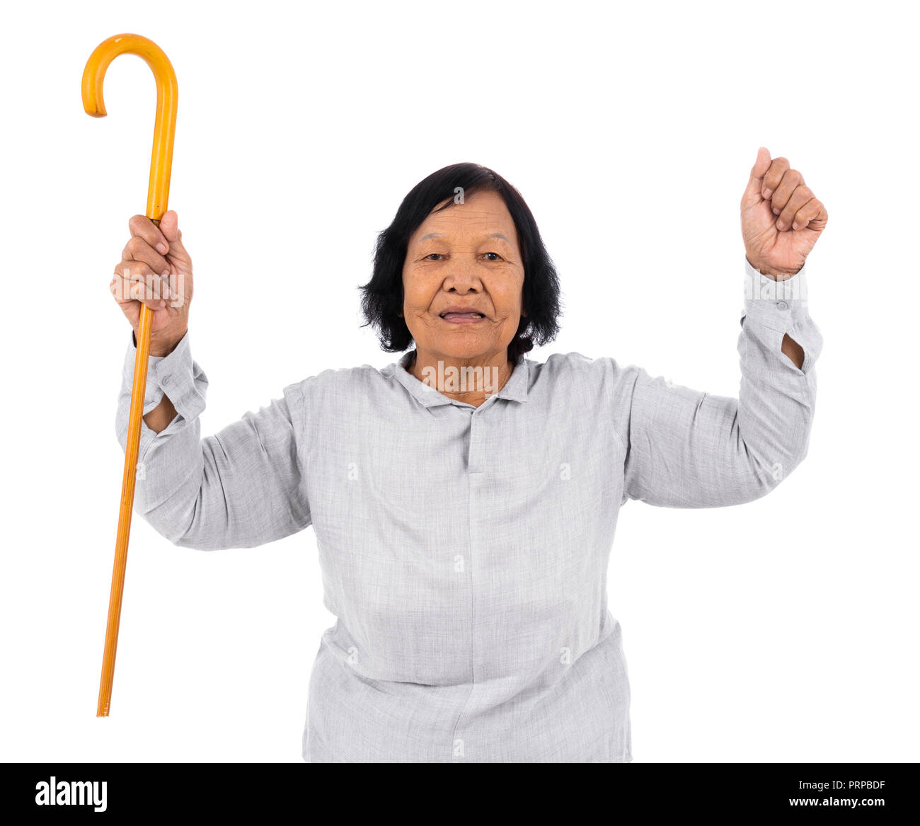 cheerful senior woman with a walking cane isolated on a white background Stock Photo