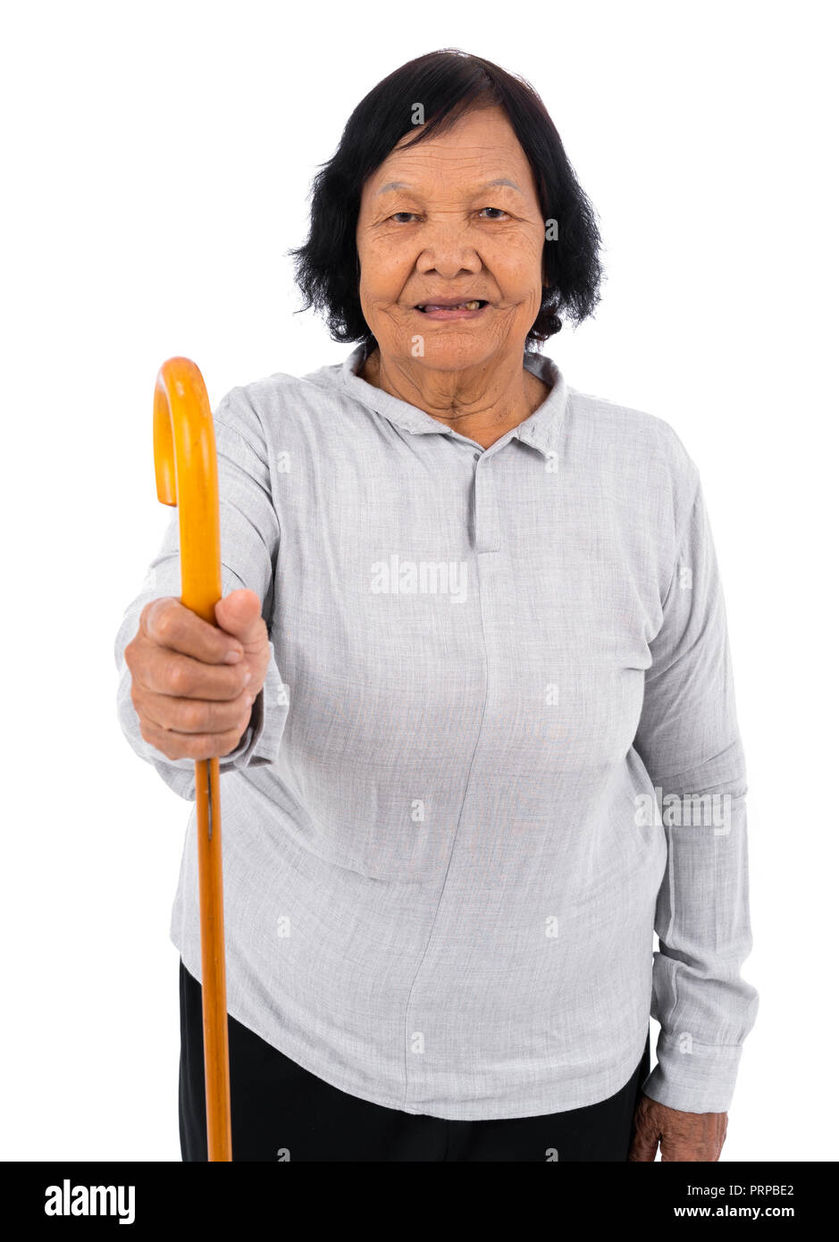 happy senior woman with a walking cane isolated on a white background Stock Photo