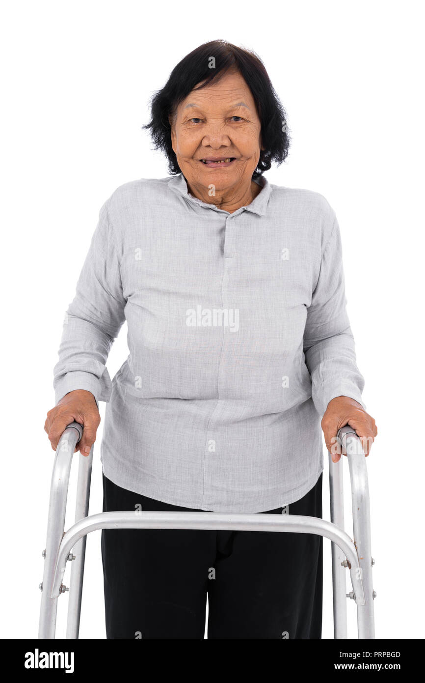 senior woman using walker isolated on a white background Stock Photo