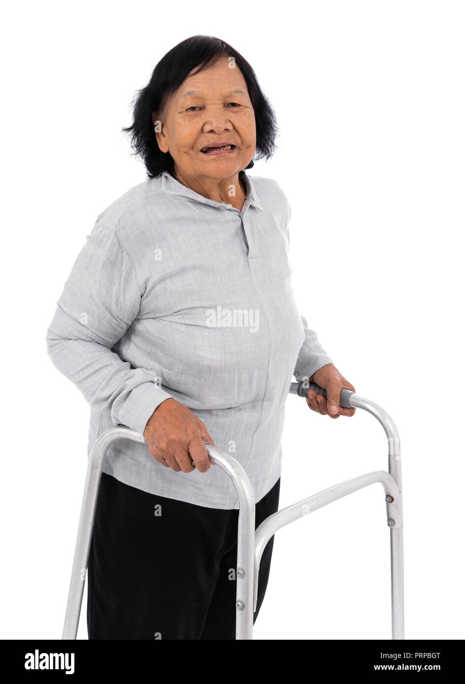 senior woman using walker isolated on a white background Stock Photo