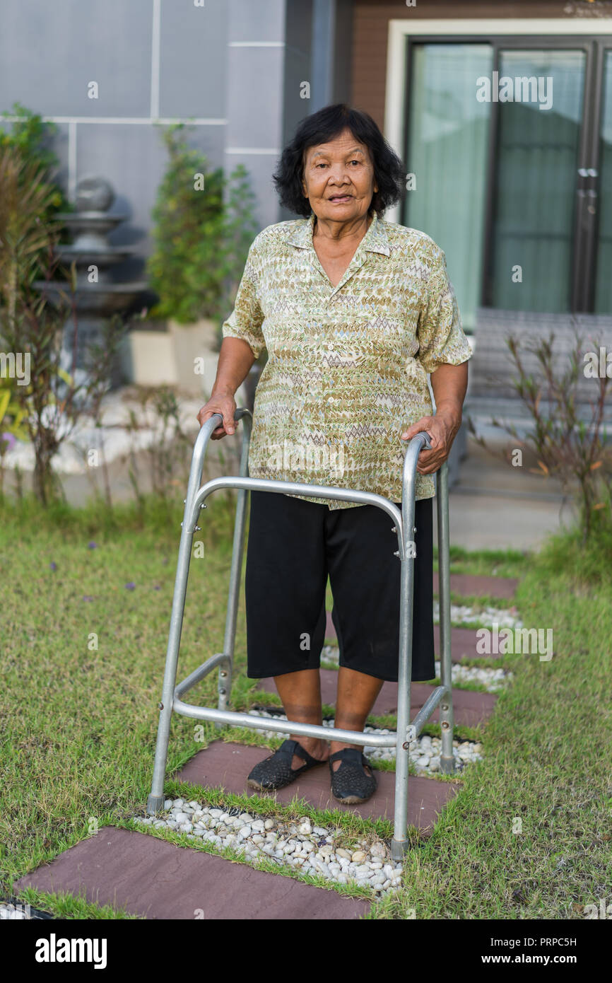senior woman walking with walker at home Stock Photo