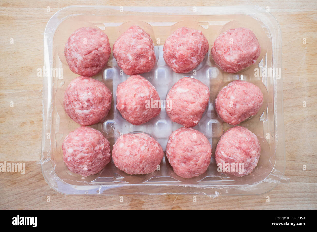 Pork meat balls. Package over cutting board Stock Photo