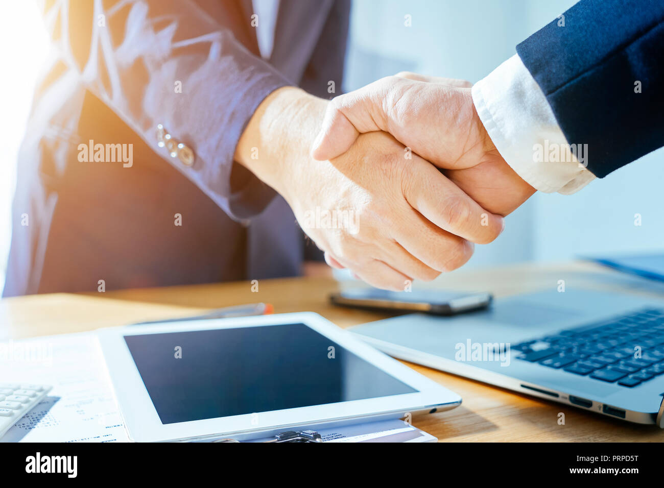 Close up of two businessmen shaking hands when finishing up a meeting . Stock Photo